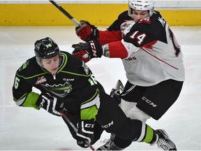 Edmonton Oil Kings Davis Koch, left, gets hit by Prince George Cougars Colby McAuley during WHL action at Rogers Place in Edmonton, Sunday, January 29, 2017. (Ed Kaiser)