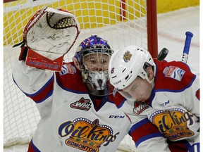 Edmonton Oil Kings goalie Patrick Dea keeps his eye on the puck as it bounces off teammate Ethan Cap on the way to a 5-2 loss to the Medicine Hat Tigers in Edmonton on Sunday, Jan. 8, 2016. (Larry Wong)