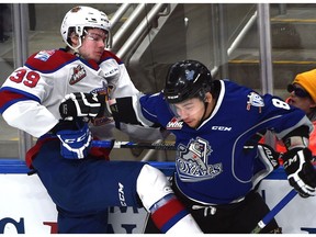 Edmonton Oil Kings Ty Gerla (39) and Victoria Royals Ethan Price (8) tangle on boards during WHL action at Rogers Place in Edmonton, Friday, January 19, 2017.