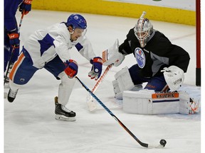 Edmonton Oiler Anton Lander attempts to score on goalie Laurent Brossoit during practice in Edmonton on Jan. 23, 2017. (Larry Wong)