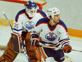Edmonton Oilers defenceman Paul Coffey monitors the play as goalie Andy Moog patrols the net during NHL action against the Los Angeles Kings on Jan. 25, 1986.