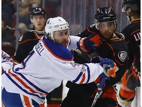 ANAHEIM, CA - JANUARY 25:  Andrew Cogliano #7 of the Anaheim Ducks is checked by Kris Russell #4 of the Edmonton Oilers during the first period at the Honda Center on January 25, 2017 in Anaheim, California.