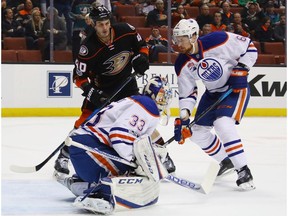 Cam Talbot #33 and Adam Larsson #6 of the Edmonton Oilers defend against Jared Boll #40 of the Anaheim Ducks during the first period at the Honda Center on January 25, 2017 in Anaheim, Calif.