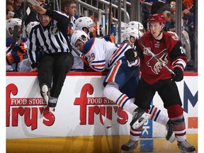 Michael Stone of the Arizona Coyotes checks Edmonton Oilers forward Leon Draisaitl at Gila River Arena on Dec. 21, 2016 in Glendale, Arizona. The Oilers defeated the Coyotes 3-2. (Getty Images)