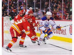 Sam Bennett #93 of the Calgary Flames chases the puck against Drake Caggiula #36 of the Edmonton Oilers during an NHL game at Scotiabank Saddledome on January 21, 2017 in Calgary.