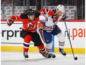 Taylor Hall of the New Jersey Devils, left, and Adam Larsson of the Edmonton Oilers pursue the puck during the second period at the Prudential Center on January 7, 2017 in Newark, New Jersey. The Oilers host the Devils on Thursday at Rogers Place.