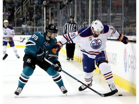 Mikkel Boedker of the San Jose Sharks and Patrick Maroon of the Edmonton Oilers go into the boards for the puck at SAP Center on Dec. 23, 2016. (Getty Images)