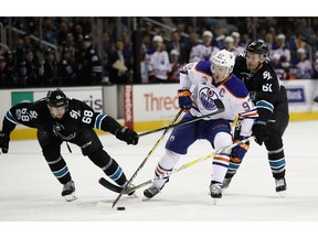 Connor McDavid of the Edmonton Oilers skates between Melker Karlsson #68 and Justin Braun #61 of the San Jose Sharks at SAP Center on Jan. 26, 2017. (Ezra Shaw/Getty Images)