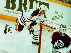 Edmonton Oilers forward Vladimir Ruzicka skates behind Winnipeg Jets goalie Bob Essensa during Ruzicka's first NHL game at Northlands Coliseum in Edmonton on Jan. 17, 1990.