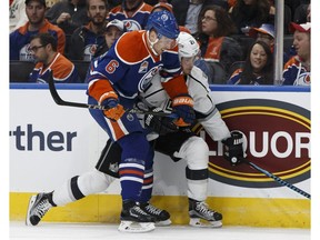 Edmonton's Adam Larsson, left, battles Los Angeles Kings' Nick Shore during the first period of a NHL game at Rogers Place in Edmonton on Thursday, December 29, 2016.