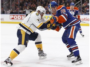 Edmonton Oilers' Drake Caggiula locks sticks with one of the Nashville Predators at Rogers Place in Edmonton on Friday, Jan. 20, 2017. (Ian Kucerak)