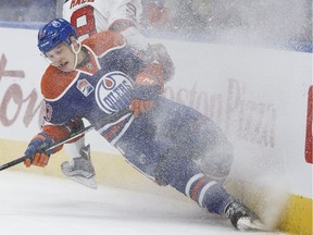 Edmonton's Matthew Benning (83) collides with New Jersey's Taylor Hall (9) during the first period of a NHL game between the Edmonton Oilers and the New Jersey Devils in Edmonton, Alberta on Thursday, January 12, 2017.