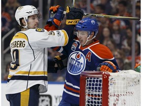 Edmonton's Ryan Nugent-Hopkins (93) and Nashville's Filip Forsberg (9) wrestle during the second period of a NHL game at Rogers Place in Edmonton on Friday, January 20, 2017.