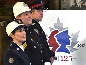 Wearing period uniforms, Det. Barb Clover, 1950 to 1975, retired Sgt. Darren Zimmerman, 1904 to 1937 and in current uniform acting Staff Sgt. Steve Sharpe (R) during the Edmonton Police Service official kick off their 125th anniversary celebrations and unveiling of the commemorative logo at police headquarters in Edmonton, Thursday, January 5, 2017. Ed Kaiser/Postmedia