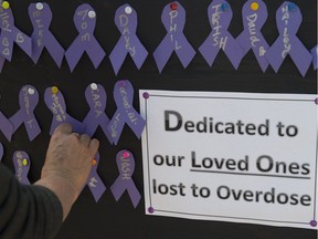 About 200 people gathered on the steps of the Alberta Legislature to Mark International Overdose Awareness day on August. 31, 2016.  Purple ribbons with the names of loved ones were pinned to a board.