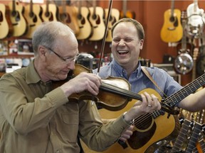 Father and son Alfie (left) and Byron Myhre play fiddle music at Myhre's Music in Edmonton on Friday, January 27, 2017. Fiddle music runs in the Myhre's veins and can be heard in their store, which celebrates its 50th anniversary this year.