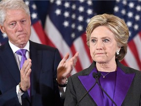 file photo taken on Nov. 9, 2016 shows  U.S. Democratic presidential candidate Hillary Clinton making a concession speech after being defeated by Republican President-elect Donald Trump, as former President Bill Clinton looks, on in New York. Defeated presidential candidate Clinton will attend Donald Trump's inauguration on Jan. 20, as will former president George W. Bush, aides to the politicians said on Jan. 3, 2017.