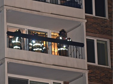 Firefighters in neighbouring suite next to where fire caused damage to a number of suites to an apartment complex on Jasper Ave. and 118 St. in Edmonton, Thursday, Jan. 19, 2017.