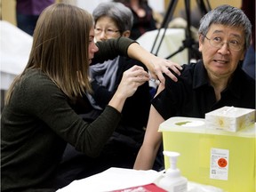 Edmontonians receive flu shots at the East Edmonton Public Health Center, 7910 - 112 Ave., in Edmonton on Monday Oct. 24, 2016. Edmonton Zone Alberta Health Services (AHS) influenza immunization clinics opened for the season on Monday. Photo by David Bloom