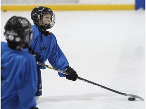 Hockey player and cancer survivor Ethan Hughes, 10, practices with his Whitemud West atom Badgers teammats at Oliver Arena in Edmonton on Saturday, Jan. 21, 2017. (Ian Kucerak)