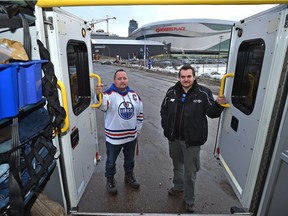 Hope Mission rescue van worker Mike Walters hands out food to a client on Thursday, December 1, 2016 in Edmonton. Greg Southam / Postmedia