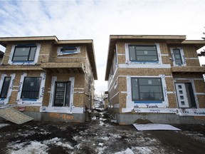 A Heritage Custom Homes infill development is seen west of 85 Street along 76 Avenue in the King Edward Park neighbourhood of Edmonton, Alta., on Sunday, Jan. 25, 2015. Infill development is underway in established neighbourhood across the Capital City and is regulated by the City of Edmonton.