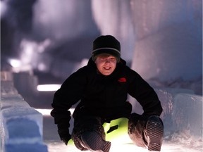 Jayden Somer from Red Deer rides a Crazy Carpet down the ice slide at Ice Castles at Hawrelak Park in Edmonton, Alberta on Friday, December 30, 2016.