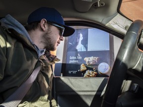 Josh McIlravey places his order Jan. 13, 2017, at the Calgary Trail Starbucks drive-thru video screen that allows him and the server to see each other.