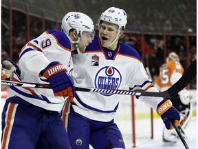 Edmonton Oilers' Jesse Puljujarvi, center, and Leon Draisaitl celebrate after Draisaitl's goal during the first period of an NHL hockey game against the Philadelphia Flyers, Thursday, Dec. 8, 2016, in Philadelphia.