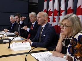 Members of the House of Commons special committee on electoral reform. Left to right: Luc Therault, Bloc Quebecois;  Scott Reid Conservative Party; Francis Scarpaleggia, Liberal Party; Nathan Cullen, NDP; and Elizabeth May, Green Party hold a news conference in Ottawa, Thursday, Dec. 1, 2016. A special all-party committee is recommending that the Trudeau government design a new proportional voting system and hold a national referendum to gauge how much Canadians would support it.