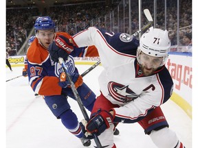 Columbus Blue Jackets' Nick Foligno is chased by Edmonton Oilers captain Connor McDavid at Rogers Place on Dec. 13, 2016.