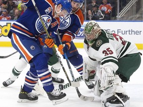 The Edmonton Oilers' Ryan Nugent-Hopkins (93) and Patrick Maroon (19) can't get the puck past the Minnesota Wild's goalie Darcy Kuemper (35) during third period NHL action at Rogers Place,  in Edmonton, Tuesday Jan. 31, 2017. Minnesota won 5-2.