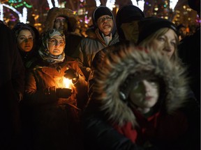 People gather in remembrance of the victims of Sunday's shooting at a Quebec City mosque in Edmonton Alta, on Monday January 30, 2017. Six people were killed and another 19 were injured when a gunman attacked the Centre Cultural Islamique de Quebec.