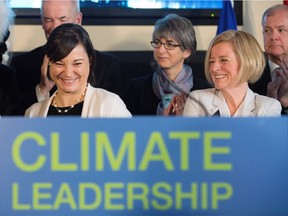 Premier Rachel Notley, right, and Environment and Parks Minister Shannon Phillips after unveiling Alberta's climate strategy in Edmonton, Alberta, on Sunday, November 22, 2015. The new plan includes a carbon tax and a cap on oilsands emissions among other strategies.