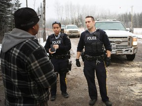 Chard Métis Society president Raoul Montgrand talks with RCMP officers near the site of the protest of construction of a TransCanada natural gas pipeline across the Christina River near Chard. Montgrand has been blocking workers from the site since Jan. 18, 2017.