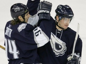 Edmonton Oilers forward Ryan Smyth, left, congratulates teammate Marc-Andre Bergeron on his second goal of the game against the Ottawa Senators during NHL action at Rexall Place in Edmonton on Jan. 14, 2006.