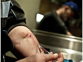 Razor, an intravenous drug user, uses a safe injection site in  the Downtown Eastside of  Vancouver in April  2011.