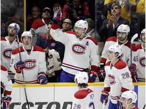 Montreal Canadiens defenceman Shea Weber, center, acknowledges the applause as a tribute to him is played on the scoreboard during the first period of an NHL hockey game between the Canadiens and the Nashville Predators on Jan. 3, 2017, in Nashville, Tenn. Weber was the captain of the Predators before being traded to the Canadiens for defenceman P. K. Subban during the off-season. (AP Photo)