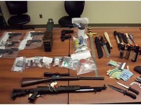 Six people are facing charges after guns, drugs and cash were uncovered during searches in Hinton, Alta.