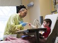 Teacher Anna Kopec works with student Gavin Penill, 7, in the Stollery Children's Hospital on Friday Jan. 20, 2017 in Edmonton.  The Stollery School allows patients to continue with their regular school work while in the hospital, to provide normalcy and routine to their days and to help students stay connected to their home schools.