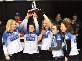 Team Kleibrink, from left, skip Shannon Kleibrink, third Lisa Eyamie, second Sarah Wilkes, lead Alison Thiessen and acting skip Heather Nedohin, hoist the trophy after defeating Team Sweeting in the final of the Alberta Scotties Tournament of Hearts provincial championship at the St. Albert Curling Club on Sunday, Jan. 29, 2017. (Ed Kaiser)