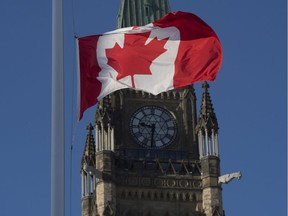 The flag flies at half-mast on a flag pole near the Peace tower Monday January 30, 2017 in Ottawa. It was announced Monday that the flag would fly at half-mast in memory of the victims of the Quebec City shooting.