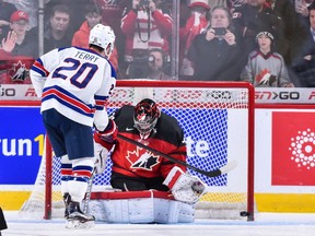 Troy Terry #20 of Team United States scores on goaltender Carter Hart #31 of Team Canada in a shootout during the 2017 IIHF World Junior Championship gold medal game at the Bell Centre on January 5, 2017 in Montreal, Quebec, Canada.  Team United States defeats Team Canada 5-4 in a shootout and wins the gold medal round.