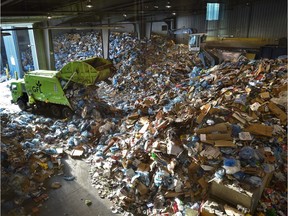 Residential recycling material is being sorted on Tuesday, Jan. 7, 2017, at the Materials Recycling Facility in Edmonton. The city collects more than twice the amount of recycling and waste in the two weeks after Christmas than is typical for the rest of January and February combined.