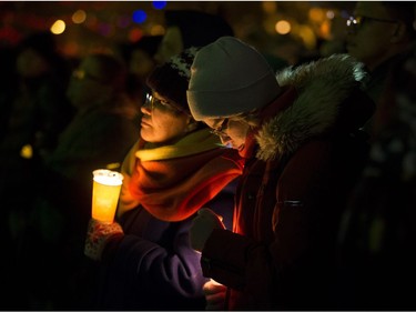 Edmontonians take part in a vigil in response to Sunday's deadly shooting at a Quebec City mosque at the Alberta Legislature in Edmonton, Monday Jan. 30, 2017.