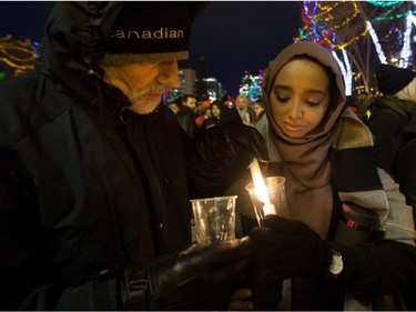 Edmontonians take part in a vigil in response to Sunday's deadly shooting at a Quebec City mosque outside the Alberta Legislature in Edmonton, Monday Jan. 30, 2017.