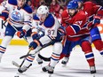 Connor McDavid #97 of the Edmonton Oilers skates the puck against Phillip Danault #24 of the Montreal Canadiens during the NHL game at the Bell Centre on February 5, 2017 in Montreal.