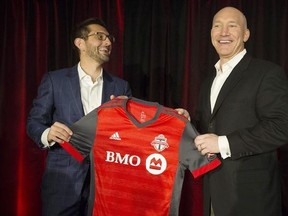 Toronto FC president Bill Manning, right, and general manager Tim Bezbatchenko unveil the team&#039;s new shirt for the forthcoming season in Toronto on Friday, February 24, 2017. THE CANADIAN PRESS/Chris Young