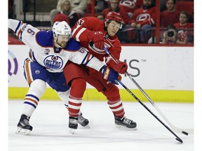 Carolina Hurricanes' Jeff Skinner (53) shoots while Edmonton Oilers' Adam Larsson (6), of Sweden, defends during the second period of an NHL hockey game in Raleigh, N.C., Friday, Feb. 3, 2017.