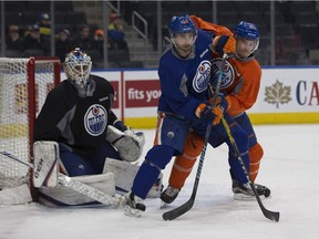 Jordan Eberle (14) battles with Brandon Davidson (88) in front of goalie Cam Talbot (33) during an Edmonton Oilers practice on Monday February 13, 2017 in Edmonton.